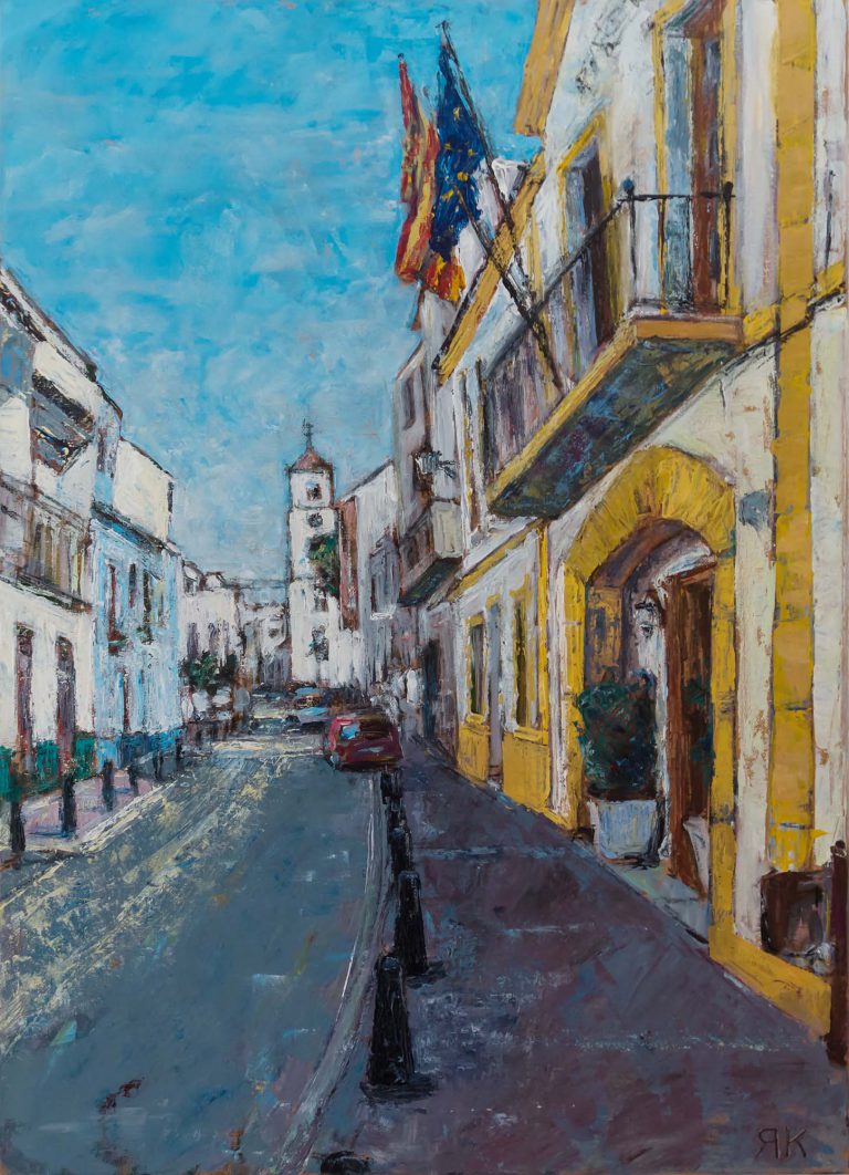 Spanish street with flags and church tower by Ria Kieboom